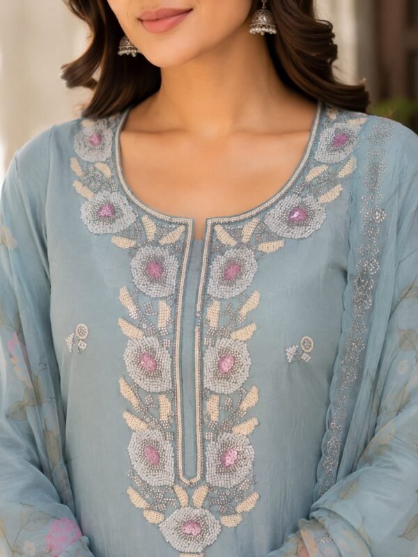 Close-up of the Powder Blue modal suit neckline with white, silver and floral beadwork.